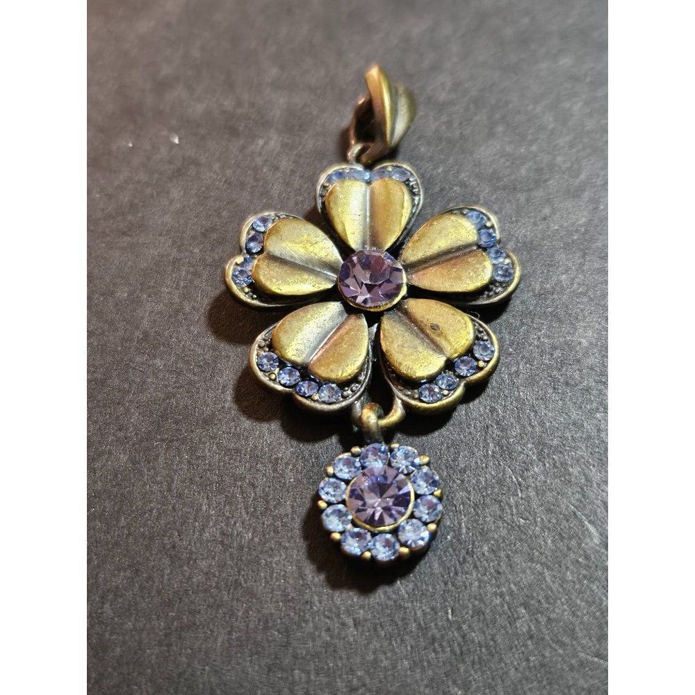 Gold tone flower pendant with rhinestones